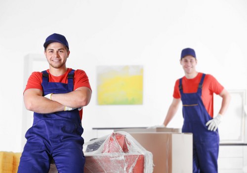 Student removal team handling boxes in an Earls Court flat move