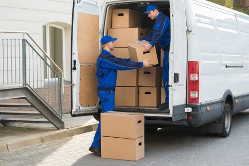 Earls Court moving service transporting furniture through a residential street