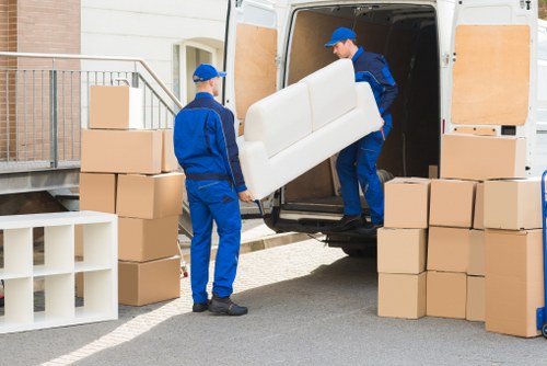 Movers using protective blankets and secure handling techniques
