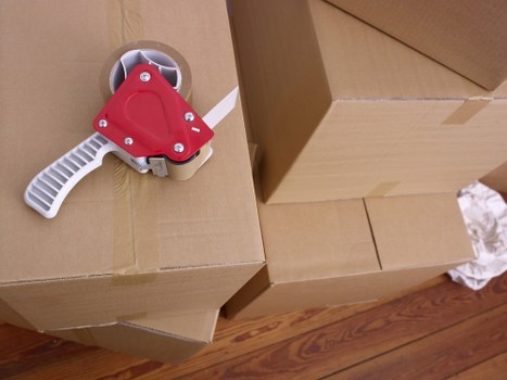 Professional movers handling furniture in a busy Earls Court street